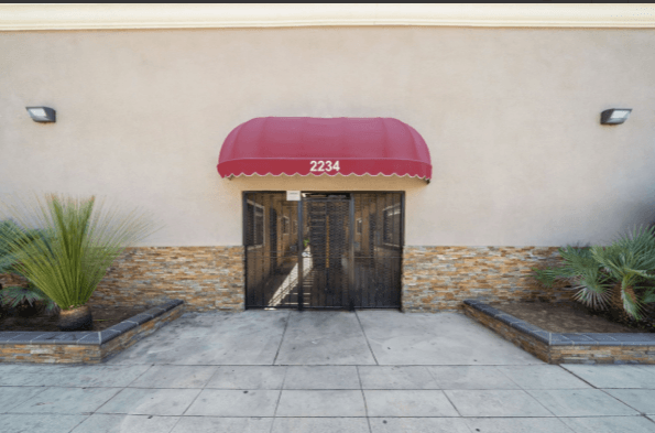 A building with a red awning and the number 2234 on it.